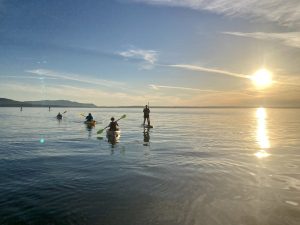 People paddling in Bellingham Bay during Sunset